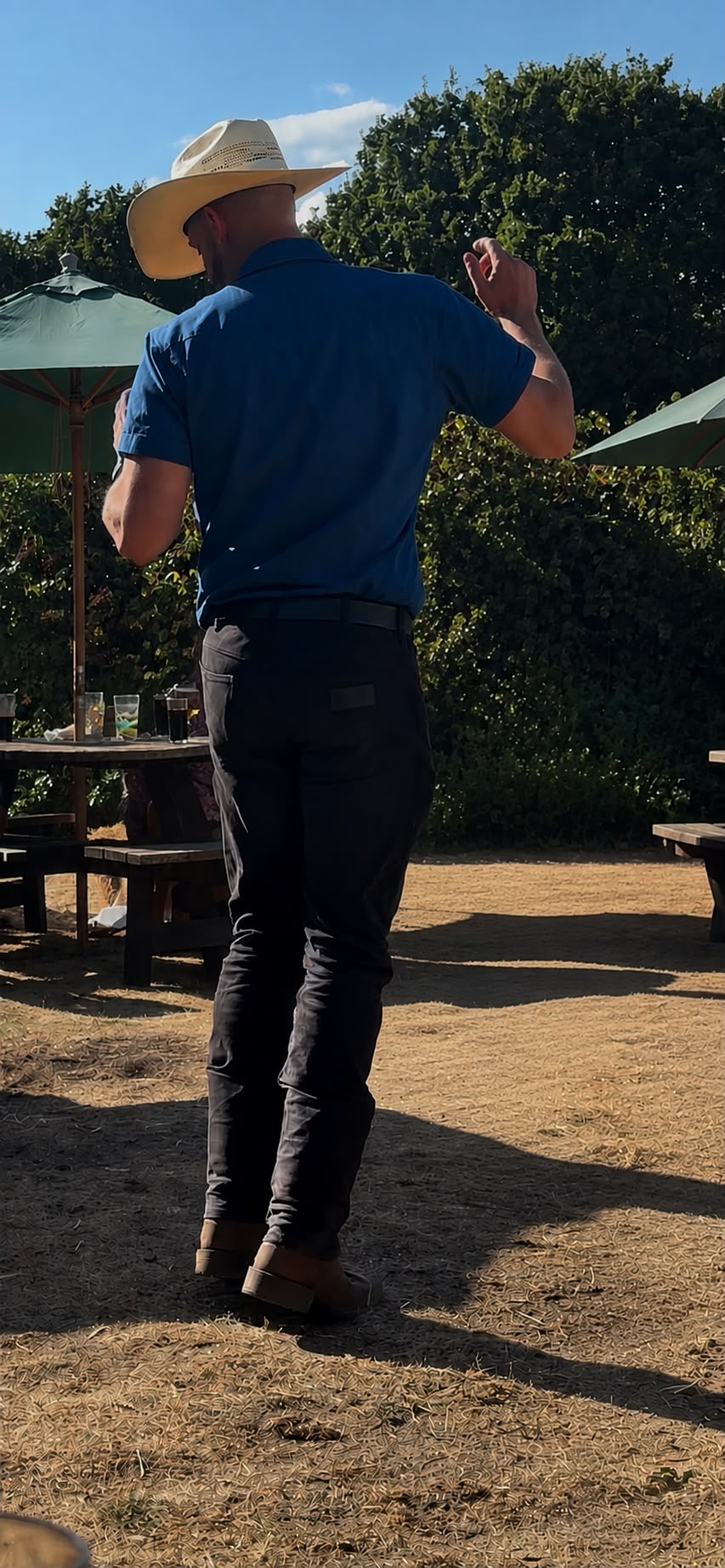 Dan Waterman demonstrating line dance steps outdoors in the summer sun